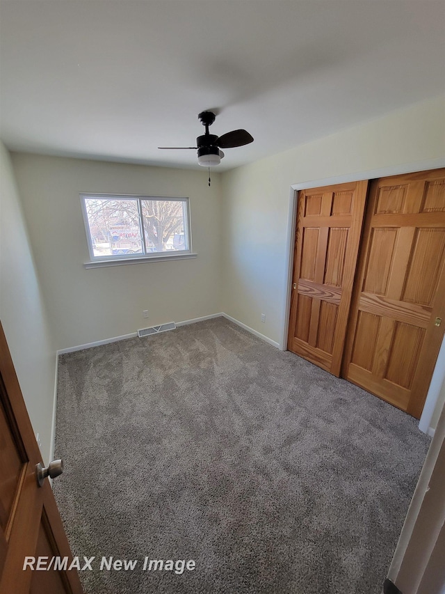 unfurnished bedroom featuring ceiling fan and carpet floors