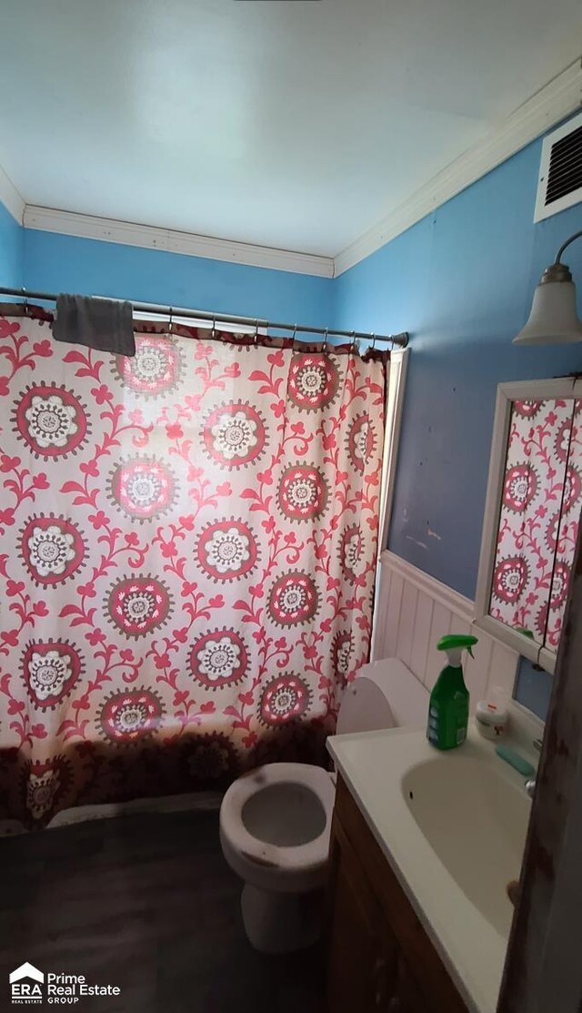 3412 Comstock Ave, Flint, MI 48504 - bathroom with wainscoting, toilet, vanity, wood finished floors, and curtained shower