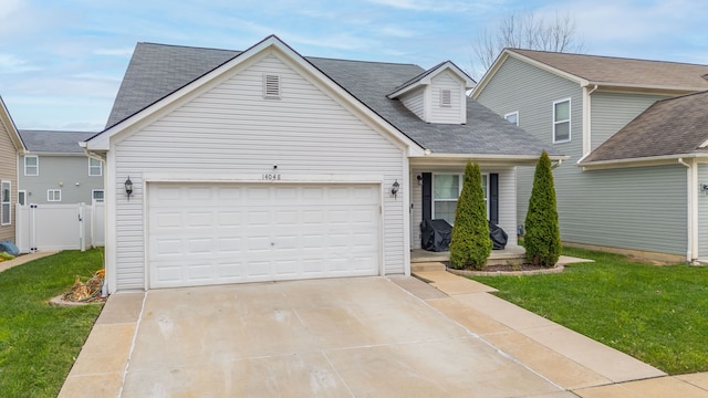 view of front of home featuring a front lawn and a garage