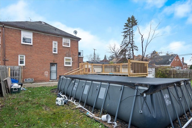 view of swimming pool with a lawn and a deck