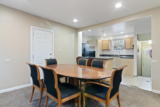 dining area featuring light carpet