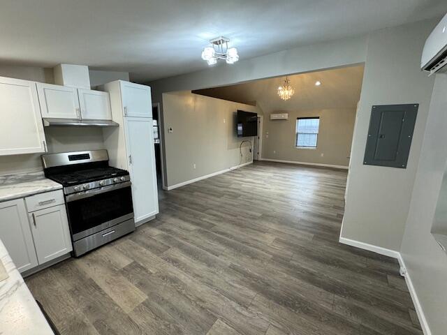 kitchen featuring dark hardwood / wood-style flooring, electric panel, white cabinetry, and stainless steel range with gas cooktop