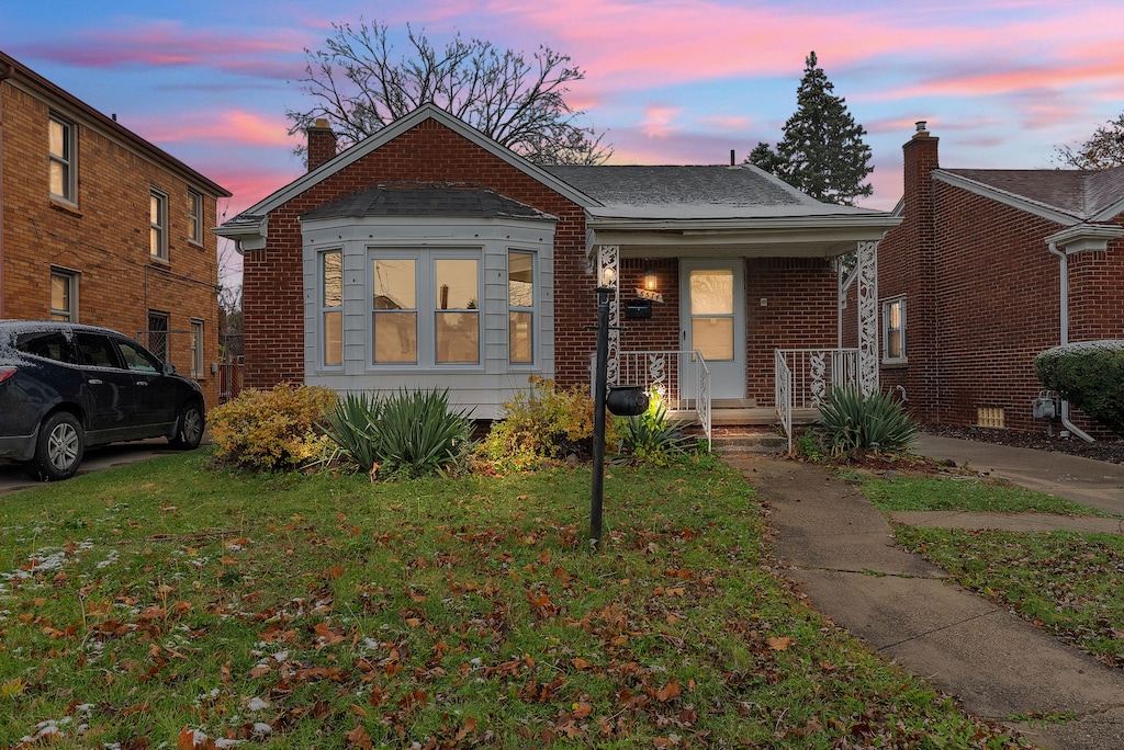 bungalow-style house featuring a yard