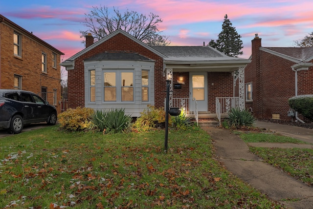 bungalow-style house featuring a yard