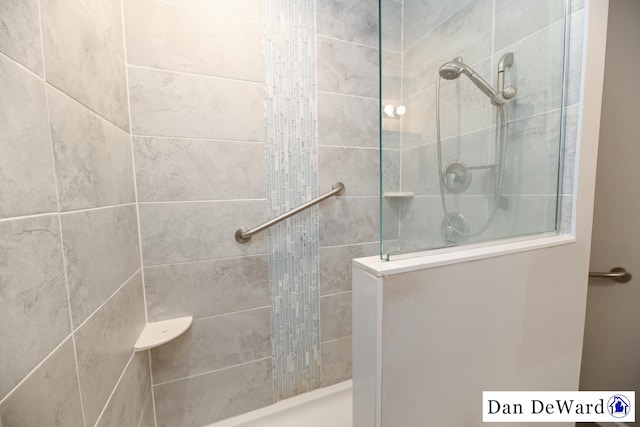 bathroom with tiled shower