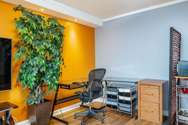 office featuring baseboards, a textured ceiling, and wood finished floors