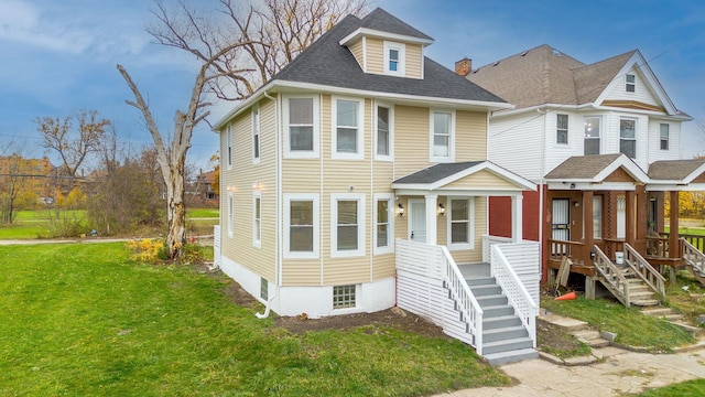 view of front of house with covered porch and a front yard