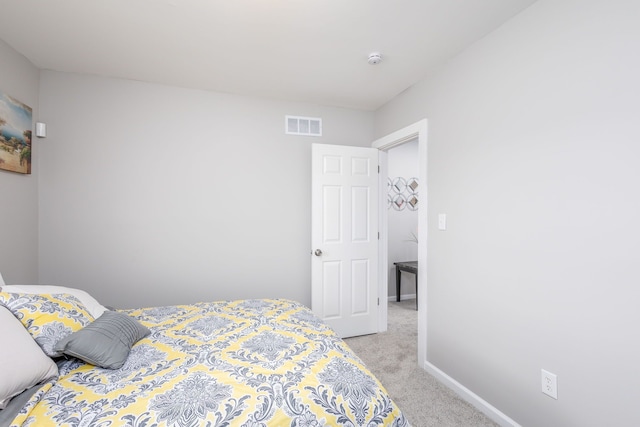 bedroom featuring light carpet