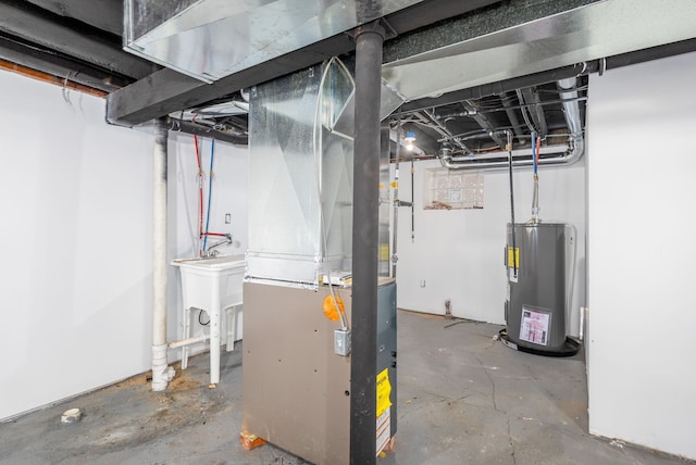 basement with electric water heater, sink, and heating unit