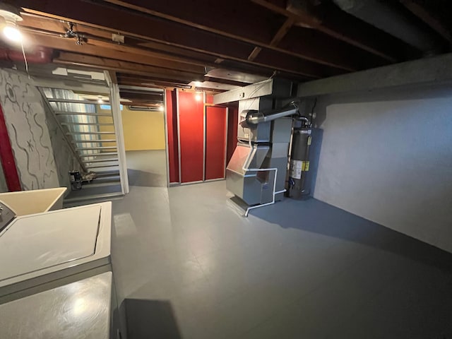 basement with heating unit, washer / clothes dryer, and water heater
