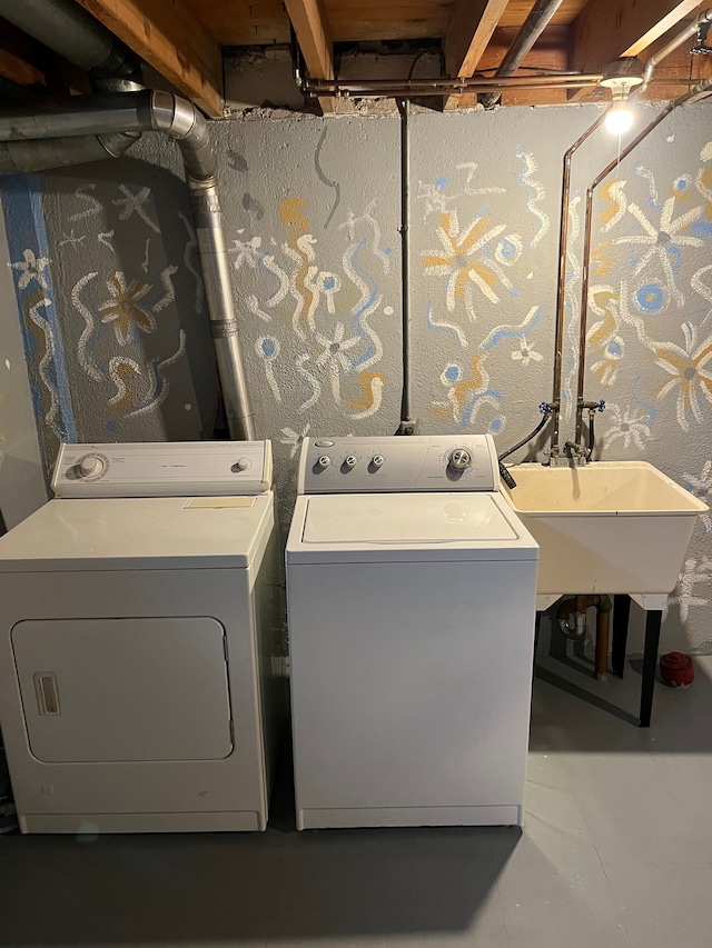 clothes washing area with washer and clothes dryer