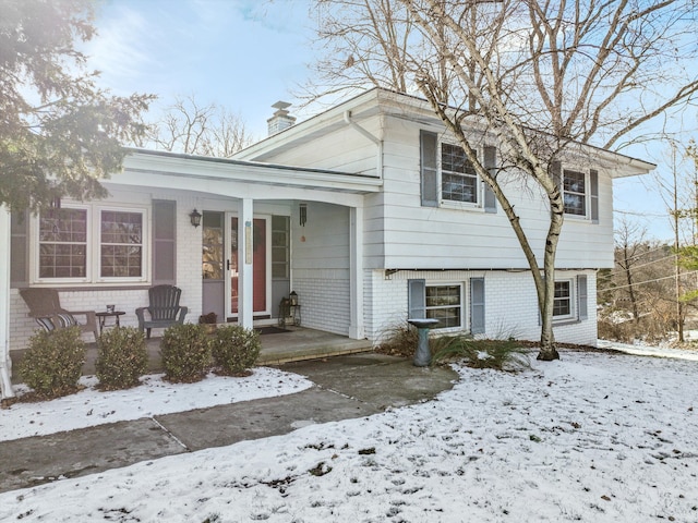 split level home featuring covered porch