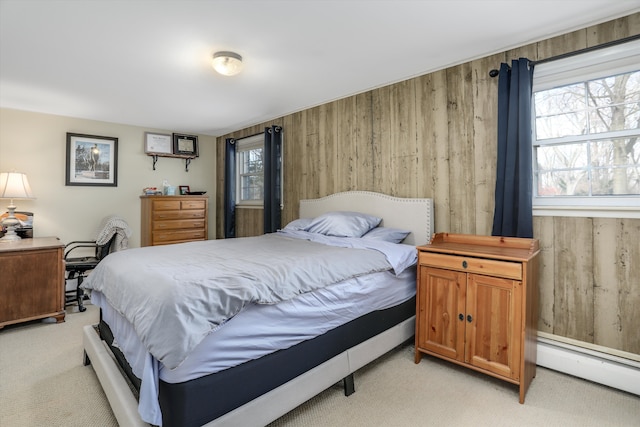 bedroom featuring multiple windows, a baseboard heating unit, and wood walls