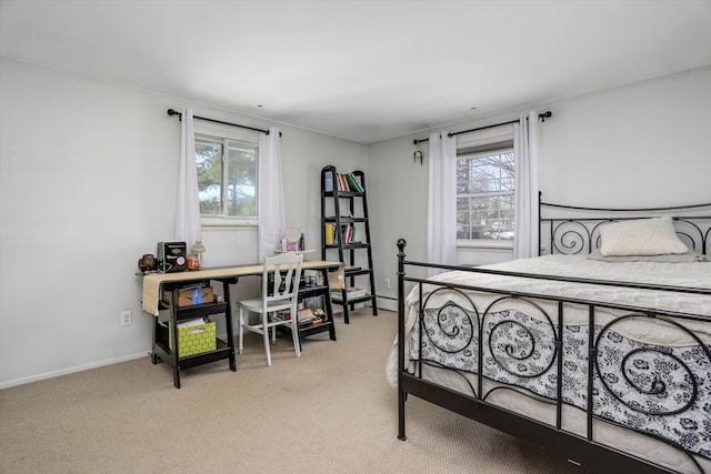 bedroom with multiple windows and light colored carpet