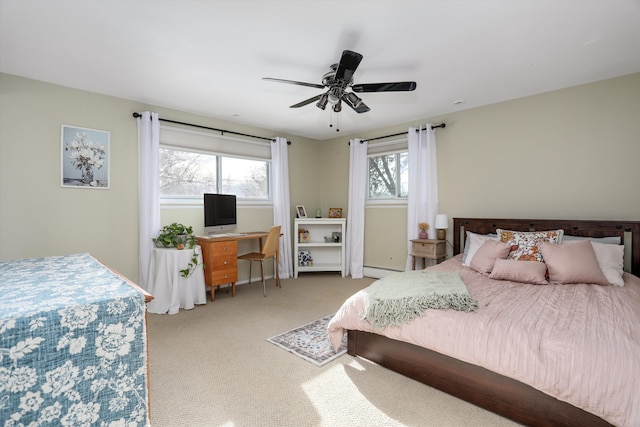 bedroom featuring ceiling fan, light colored carpet, and a baseboard heating unit