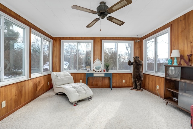 sunroom / solarium featuring plenty of natural light and ceiling fan