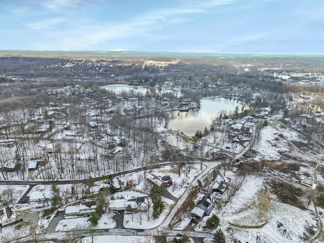 snowy aerial view with a water view