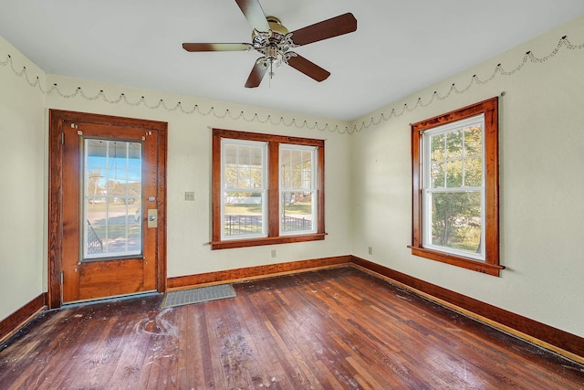 empty room featuring dark hardwood / wood-style flooring and ceiling fan