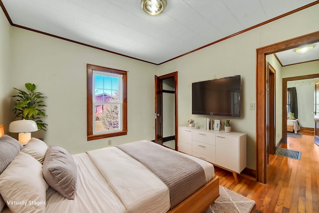 bedroom featuring light hardwood / wood-style floors and ornamental molding