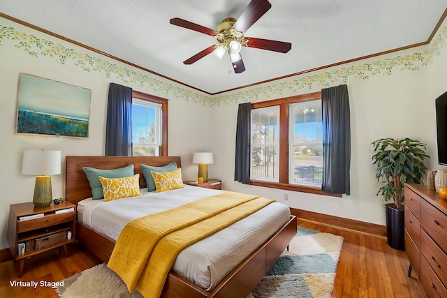 bedroom featuring ceiling fan, dark hardwood / wood-style flooring, and crown molding