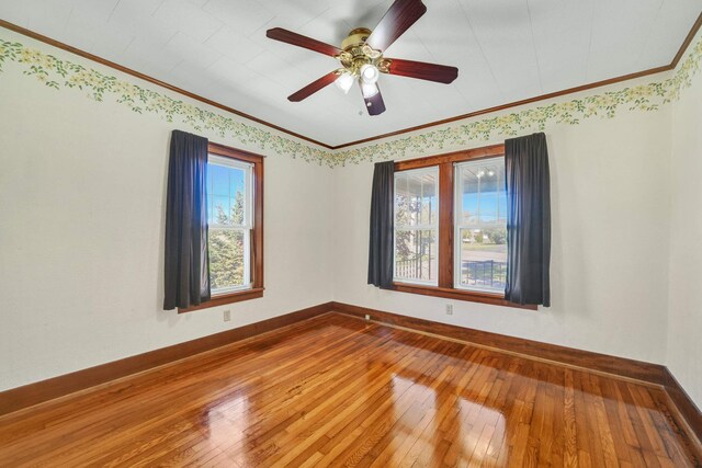 unfurnished room featuring hardwood / wood-style floors, ceiling fan, and ornamental molding