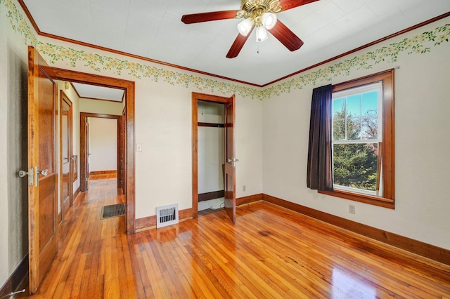 unfurnished bedroom featuring hardwood / wood-style flooring, ceiling fan, and ornamental molding