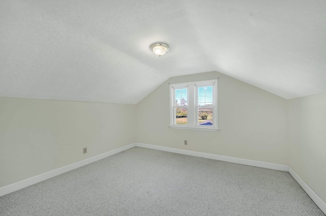 bonus room featuring carpet flooring and lofted ceiling