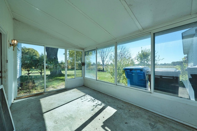 unfurnished sunroom featuring vaulted ceiling