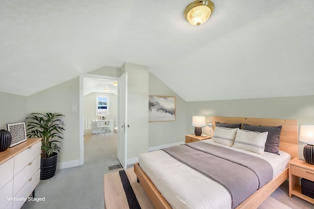 bedroom featuring light carpet and vaulted ceiling