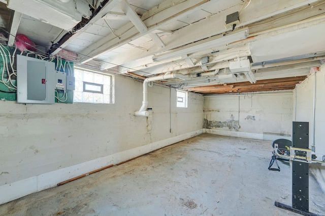 basement featuring a healthy amount of sunlight and electric panel