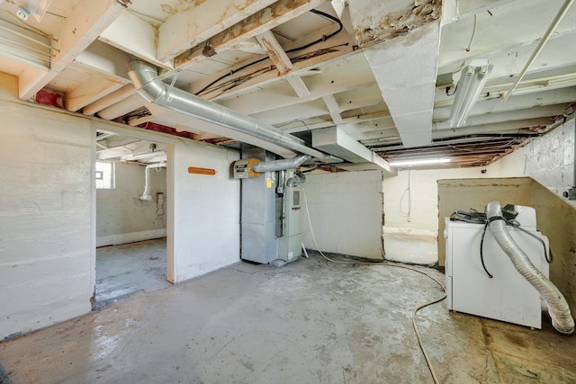 basement with washer / dryer and heating unit