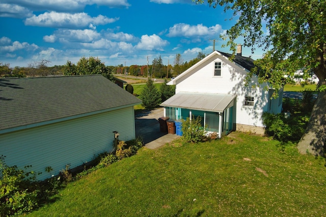 back of property featuring a lawn