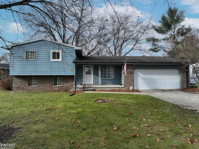 tri-level home featuring a front lawn and a garage