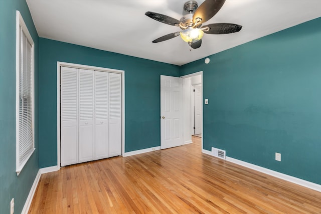 unfurnished bedroom with a closet, ceiling fan, and light wood-type flooring