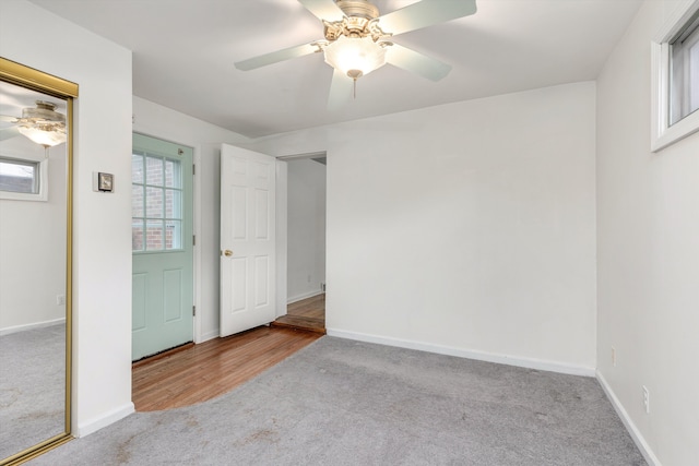 unfurnished bedroom featuring ceiling fan and light colored carpet