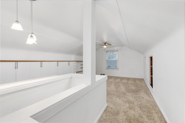 additional living space with vaulted ceiling and light carpet