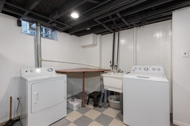 laundry room with separate washer and dryer and sink