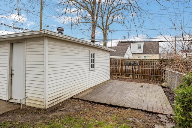 exterior space featuring a wooden deck and an outbuilding