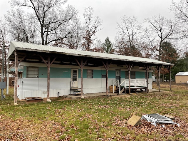 back of house with a lawn