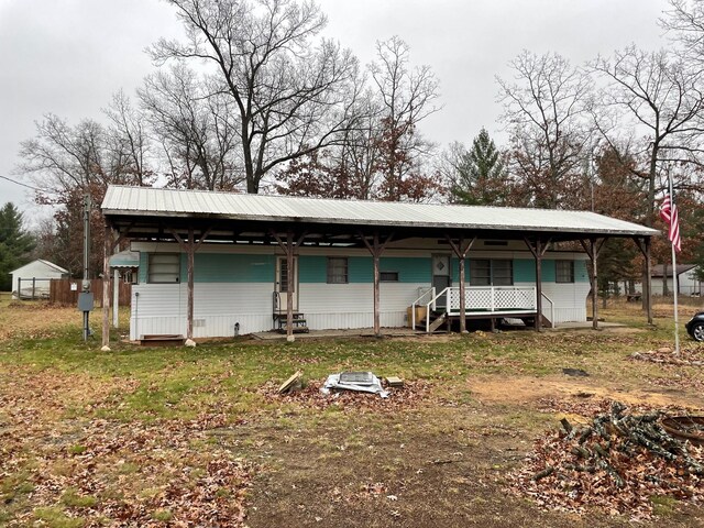 3867 Susan St, Wellston, MI 49689 - view of front of home featuring metal roof and covered porch
