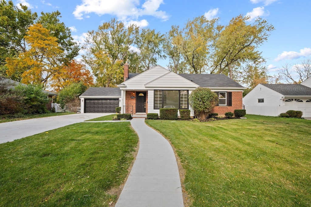 view of front of home with a garage and a front lawn