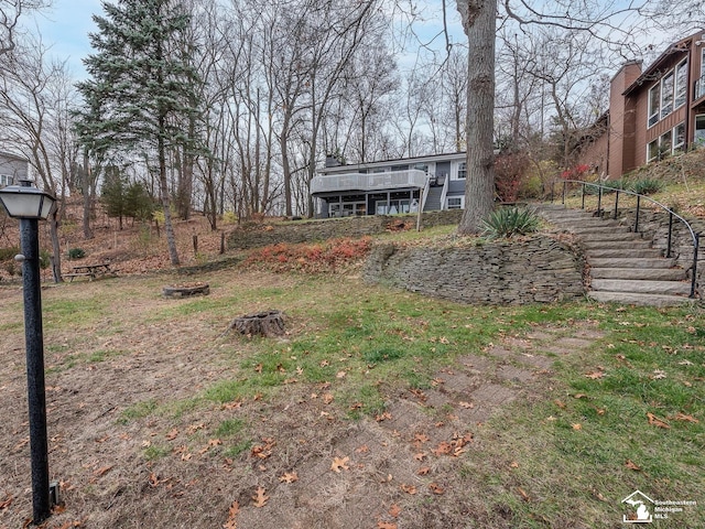11477 Highland Hills Dr, Jerome, MI 49249 - view of yard with stairs, a fire pit, and a deck