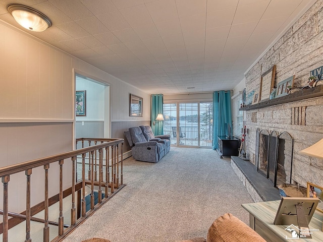 11477 Highland Hills Dr, Jerome, MI 49249 - carpeted living area with a stone fireplace, crown molding, and baseboard heating