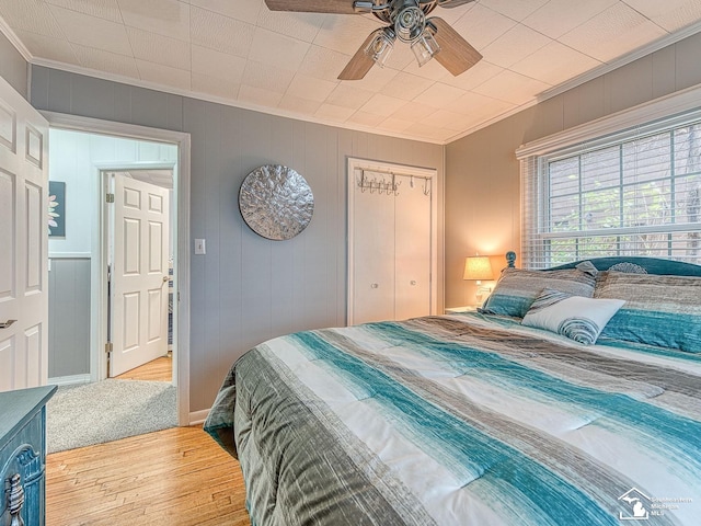 11477 Highland Hills Dr, Jerome, MI 49249 - bedroom with ornamental molding, wood finished floors, a closet, ceiling fan, and baseboards