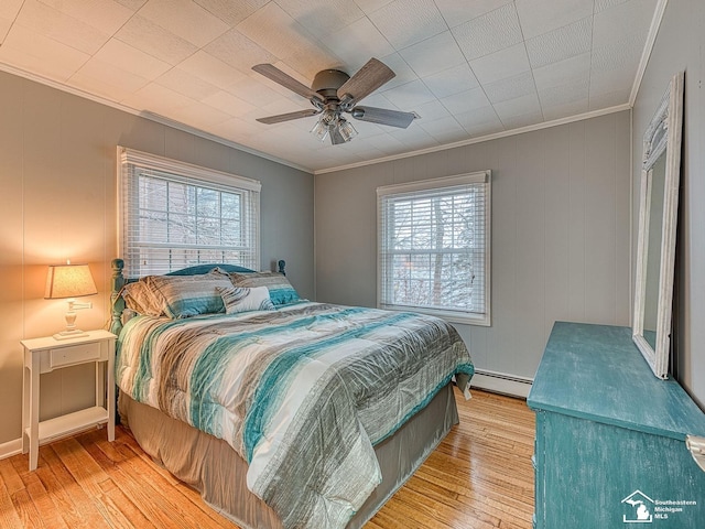 11477 Highland Hills Dr, Jerome, MI 49249 - bedroom with crown molding, a baseboard heating unit, wood finished floors, and ceiling fan