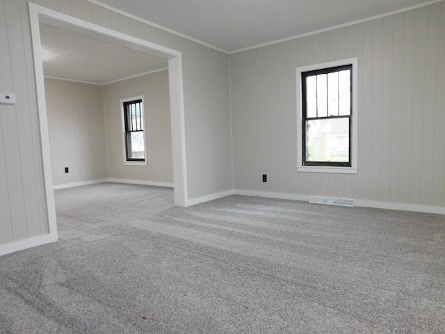 unfurnished room featuring light carpet and crown molding