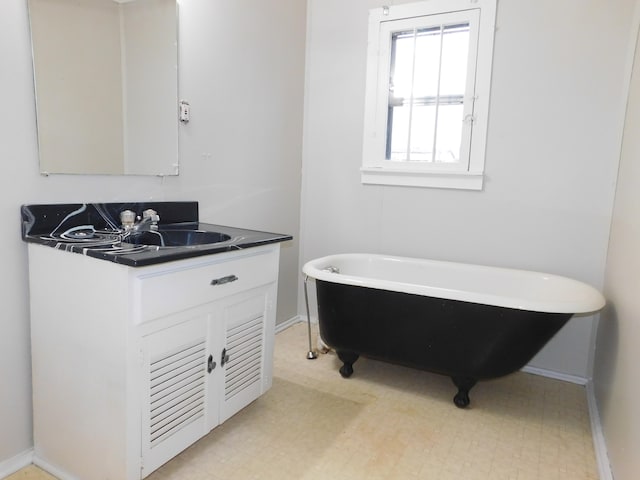 bathroom featuring a tub to relax in and vanity