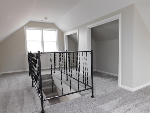 stairs featuring carpet and lofted ceiling