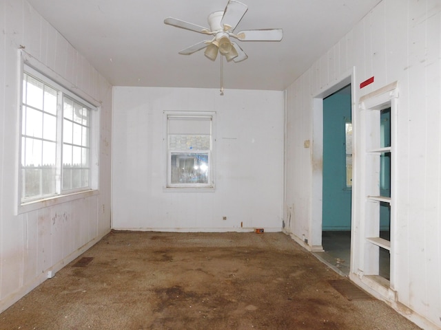 2265 Holly St, Benton Harbor, MI 49022 - empty room featuring ceiling fan and wood walls
