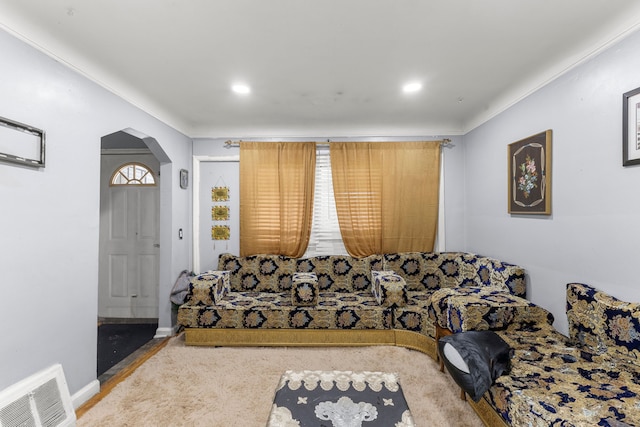 living room featuring carpet floors and crown molding